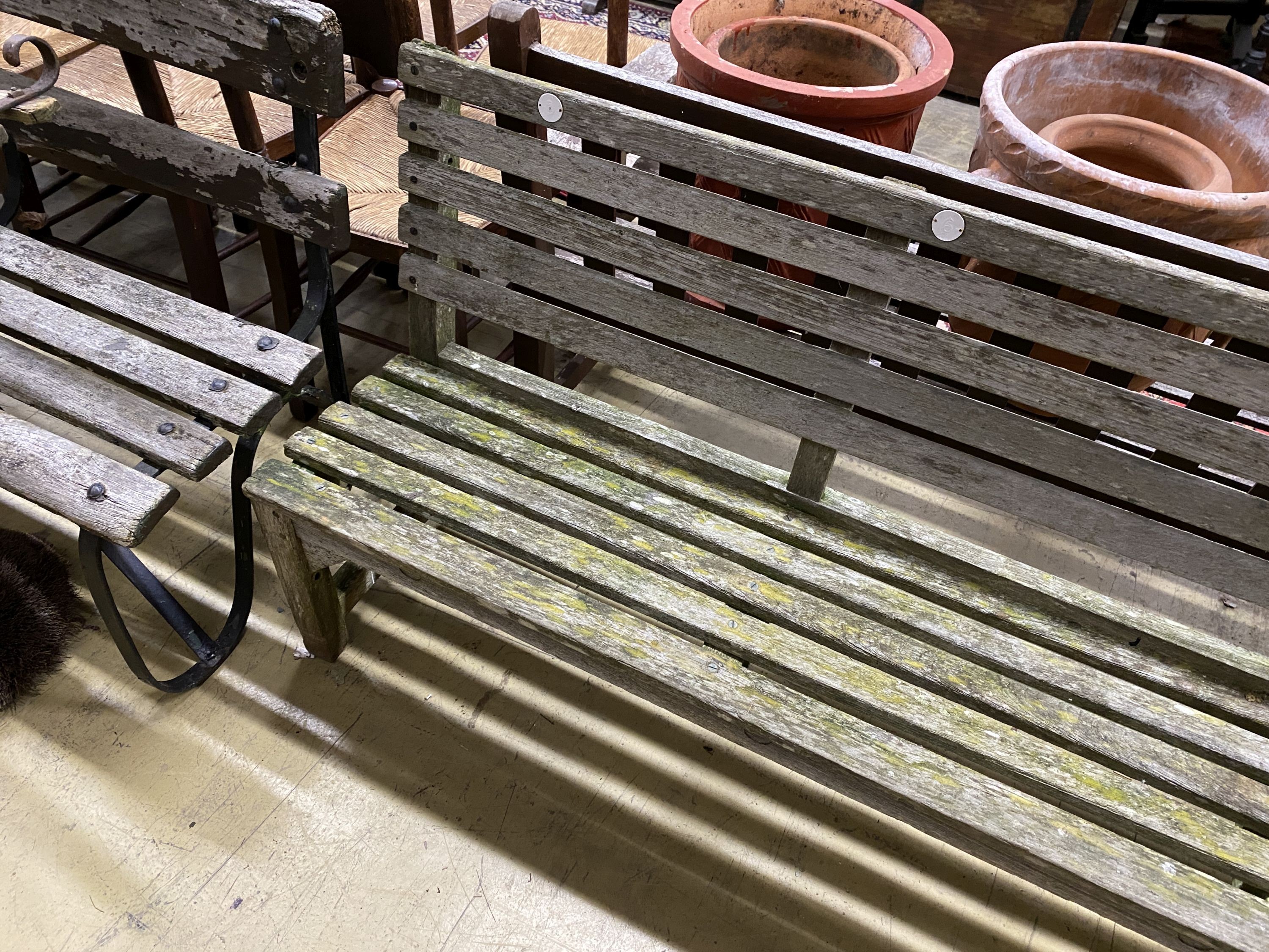 A weathered teak garden bench, length 183cm, depth 39cm, height 80cm